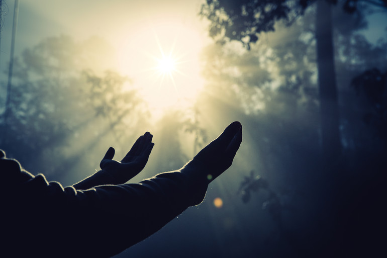 Teenage girl with praying in sunny nature. Young girl meditate i