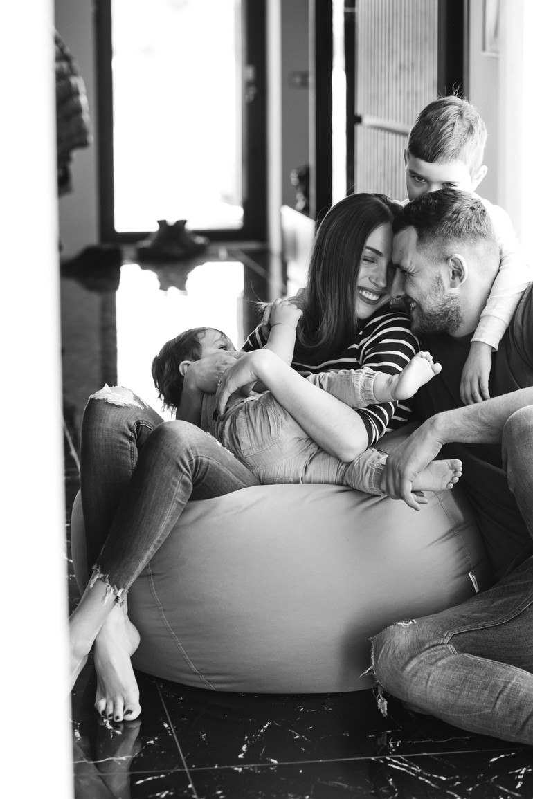 Young family with their sons at home having fun